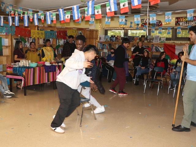 Participants dance and engage in activities in a vibrant, decorated space.