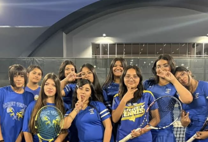 students in tennis attire pose in group photo