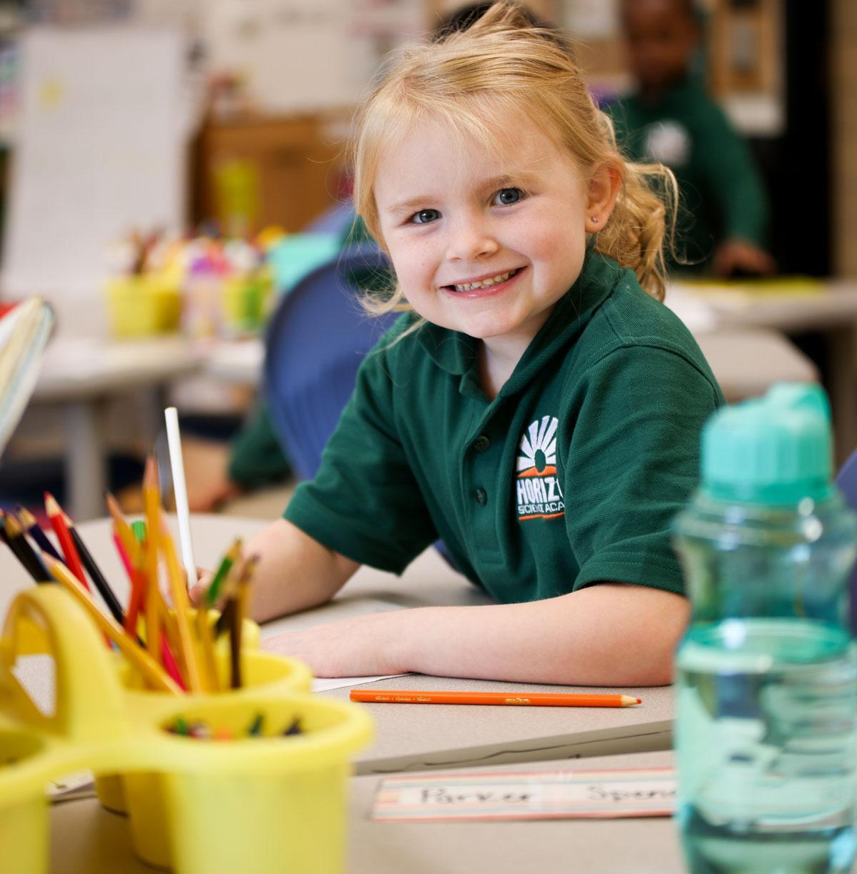 Student drawing in a classroom.