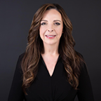 Formal head shot of a woman in a studio setting