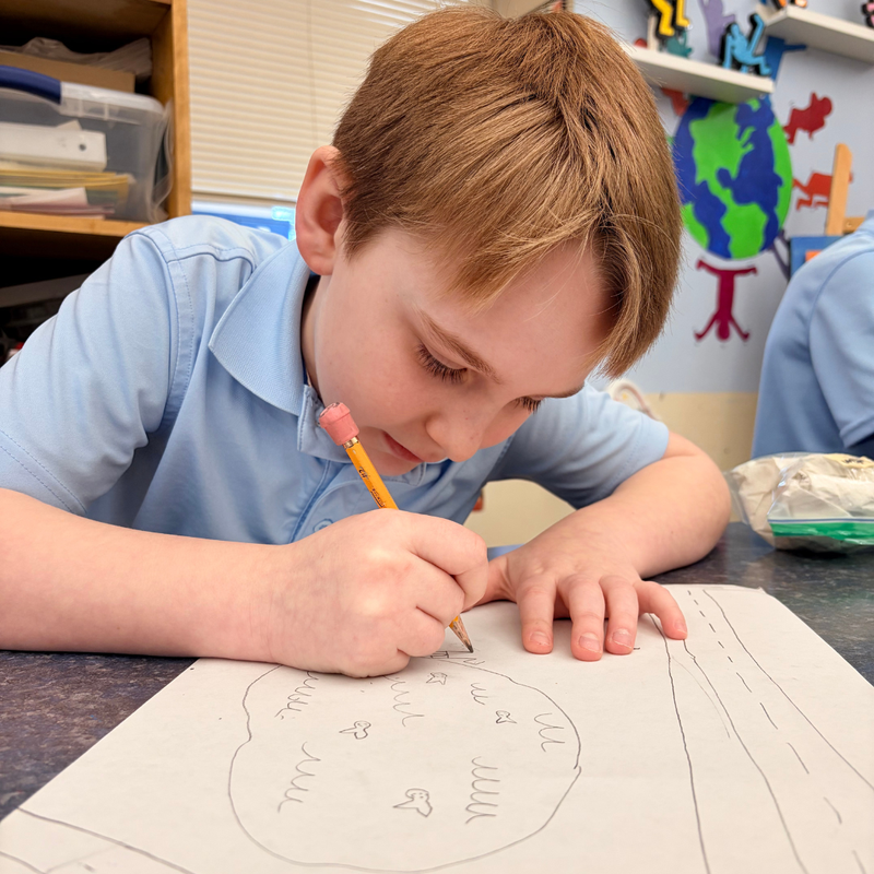 boy draws a pond in a park