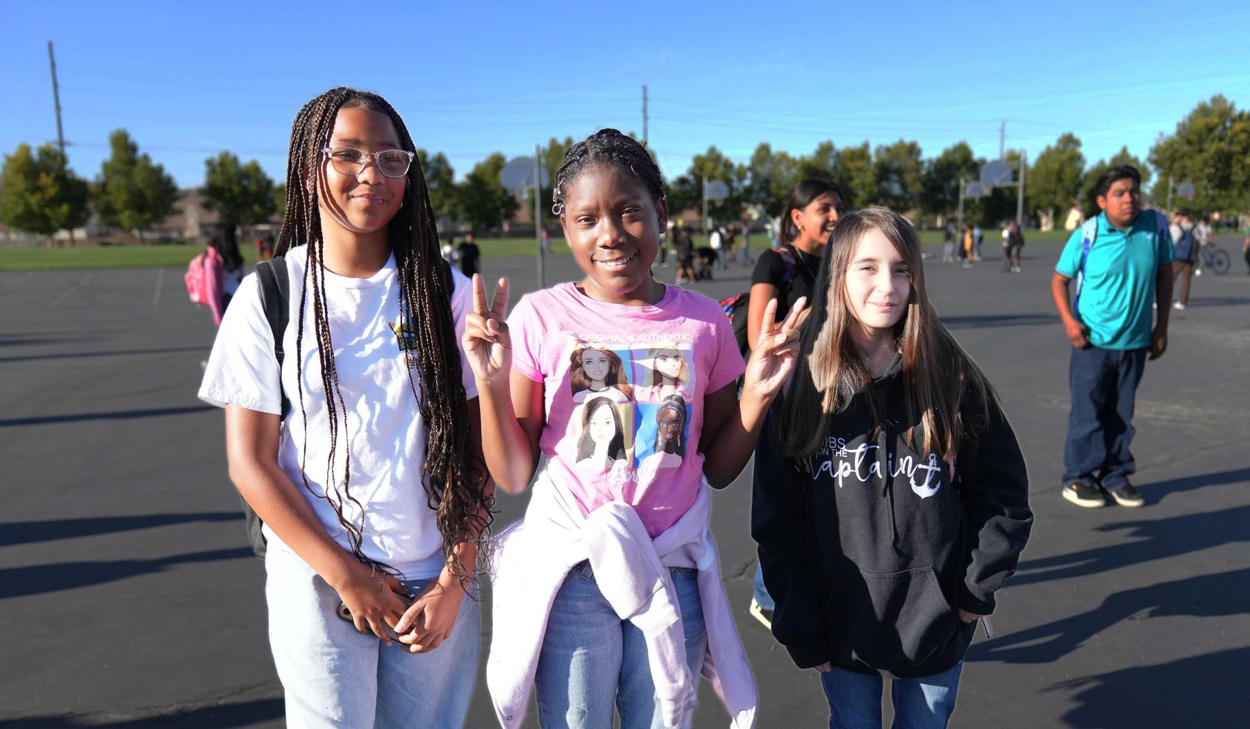 three smiling middle school girls