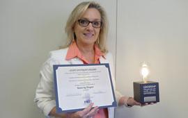 Woman holding award