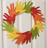 Paper cut outs of hands in the form of a wreath.