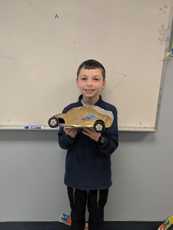 A student shows off his vintage car that he made.