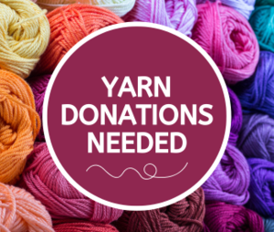 Yarn Donations Needed in maroon circle with colorful yarn skeins in the background
