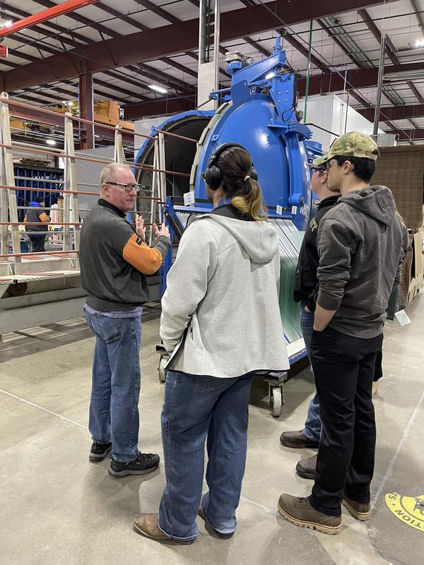 students overlooking equipment on tour