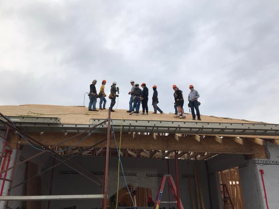 Students working on the roof of project house 26.