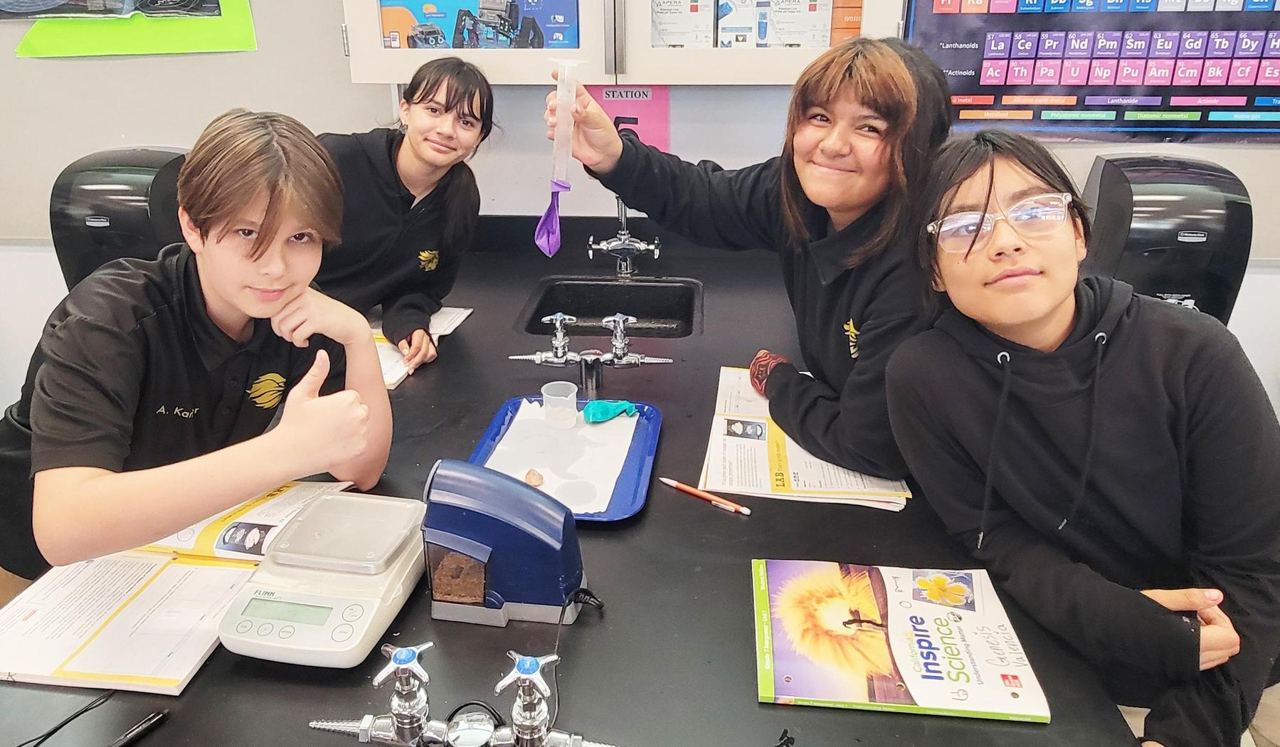 science students showing experiment equipment