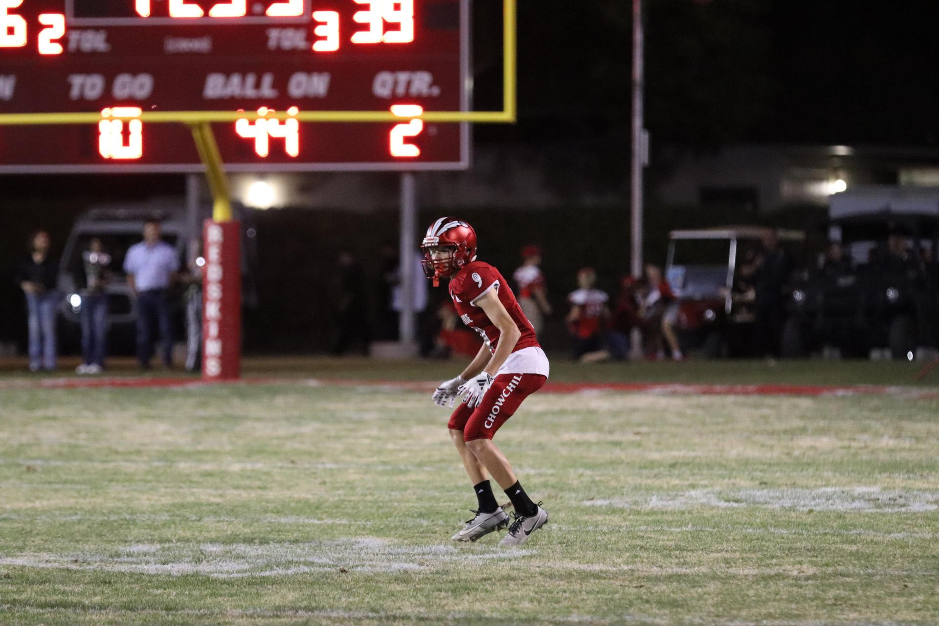 varsity football players in action against Riverdale
