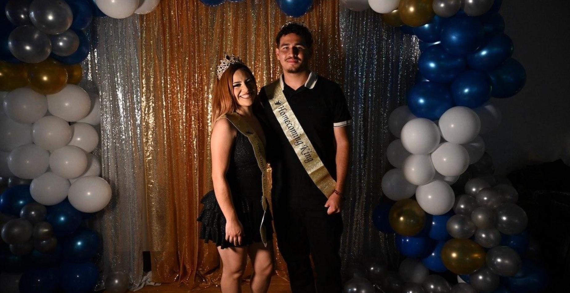 Homecoming royalty poses beneath the balloon arch at Lifeline Homecoming 2026. Select to view all homecoming photos.