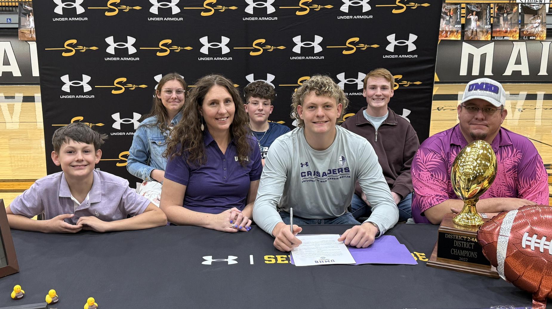 Colby Sanders signing his letter of intent to play football at the University of Mary Hardin-Baylor in Belton
