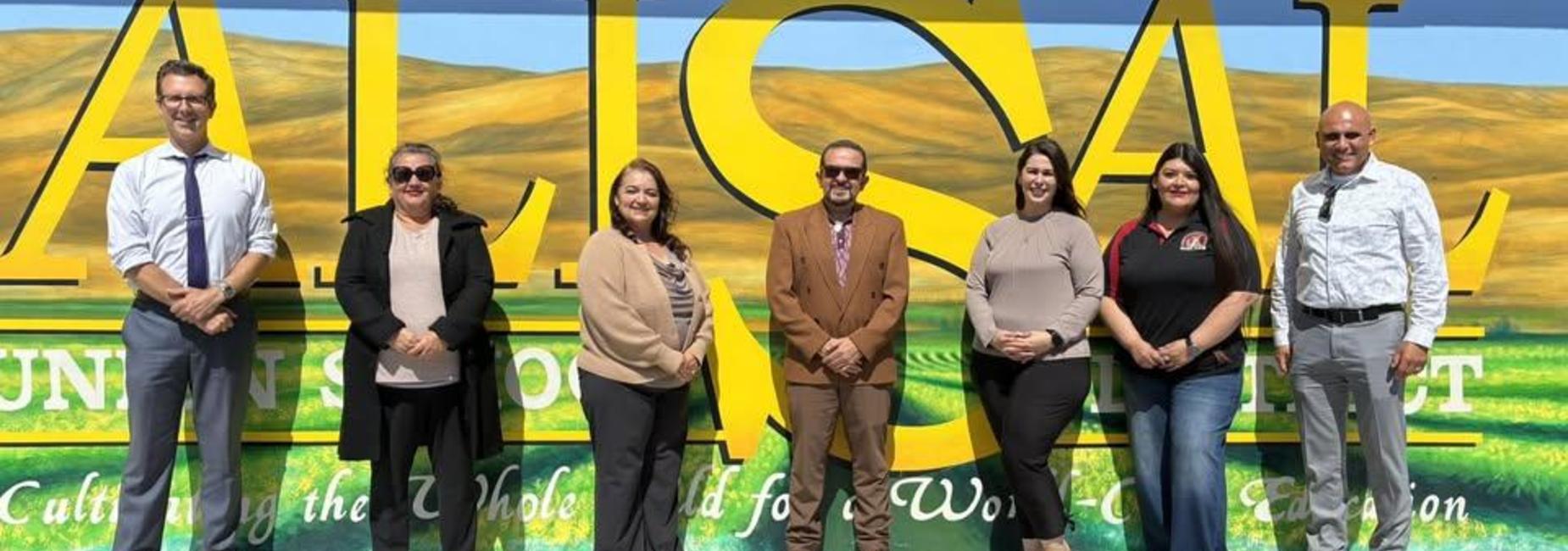Three men and four women lined up against a mural. All are Alisal USD principals.