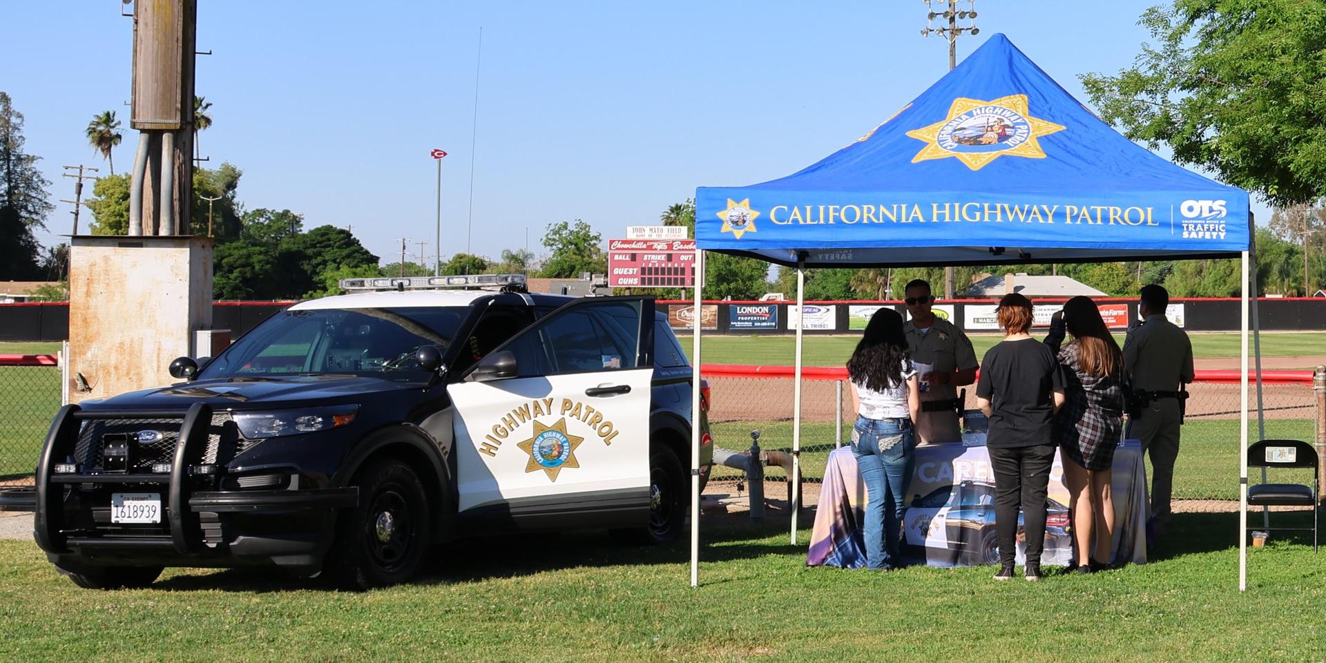 Highway patrol officers speaking to students