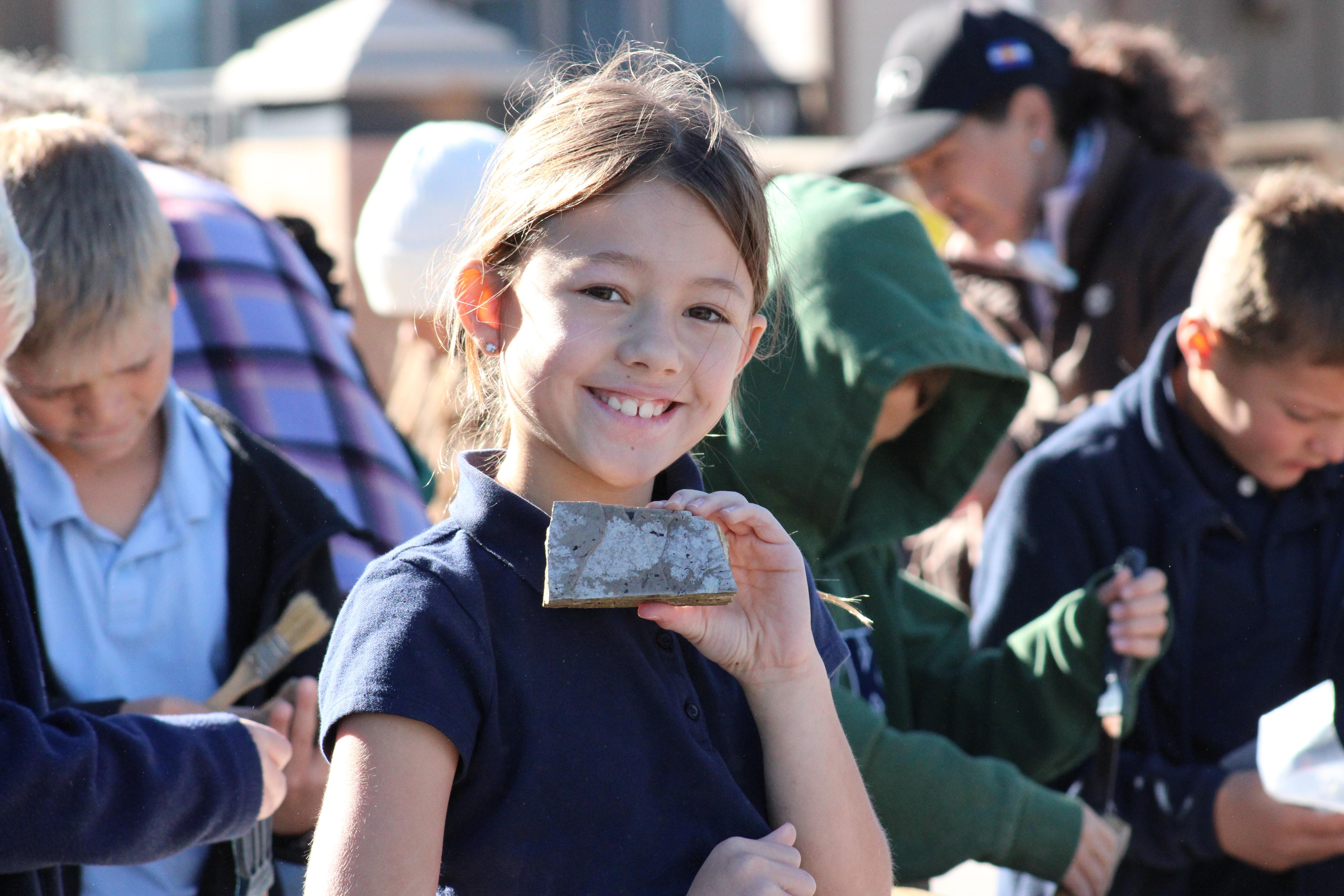 PCK student holds a fossil found during a science activity