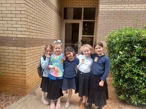 Second grade girls pose with their first day of chumash badges.