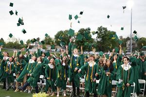 Graduates toss their caps following the ceremony
