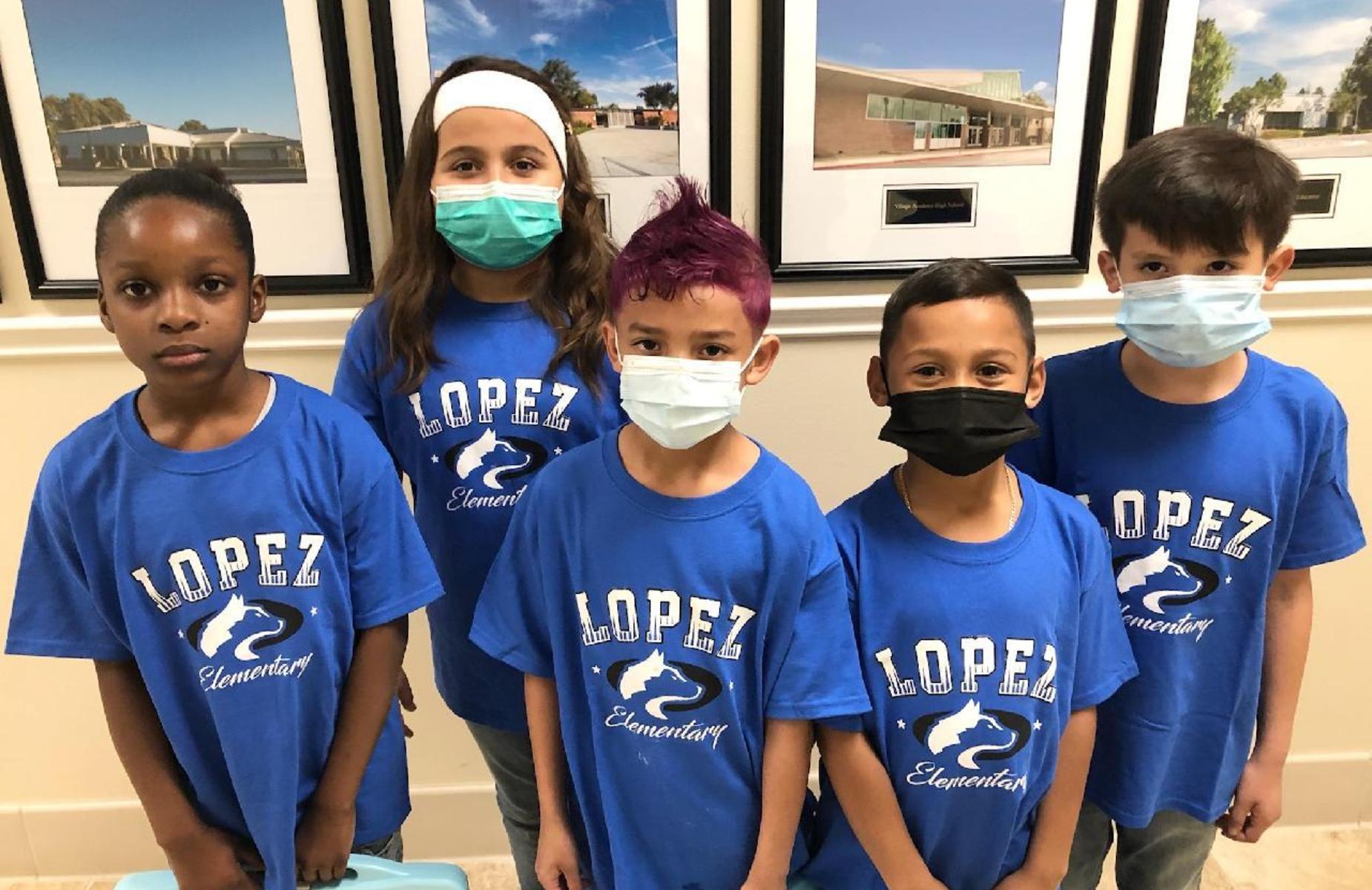 students posing for group photo wearing masks