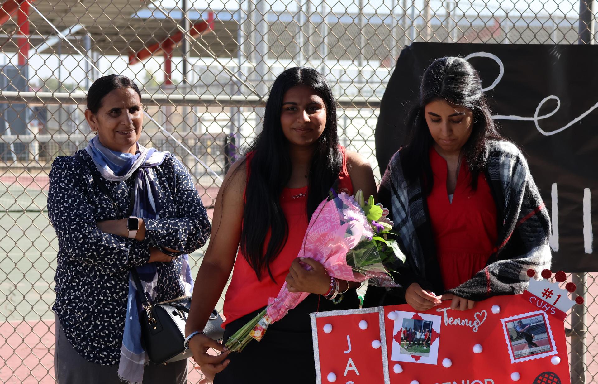 tennis players, family, and staff celebrating senior night