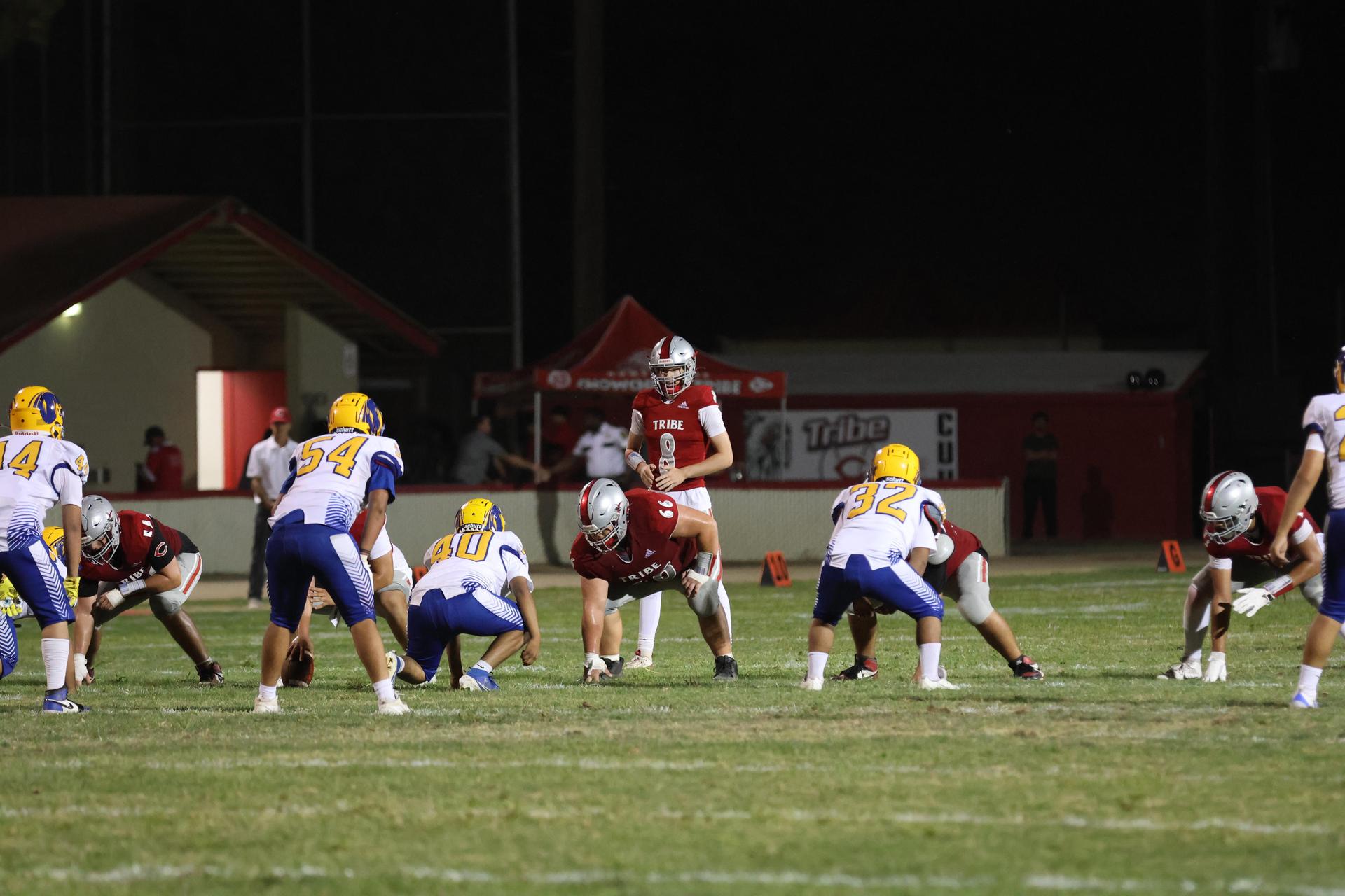 Varsity football players in action against Parlier 57