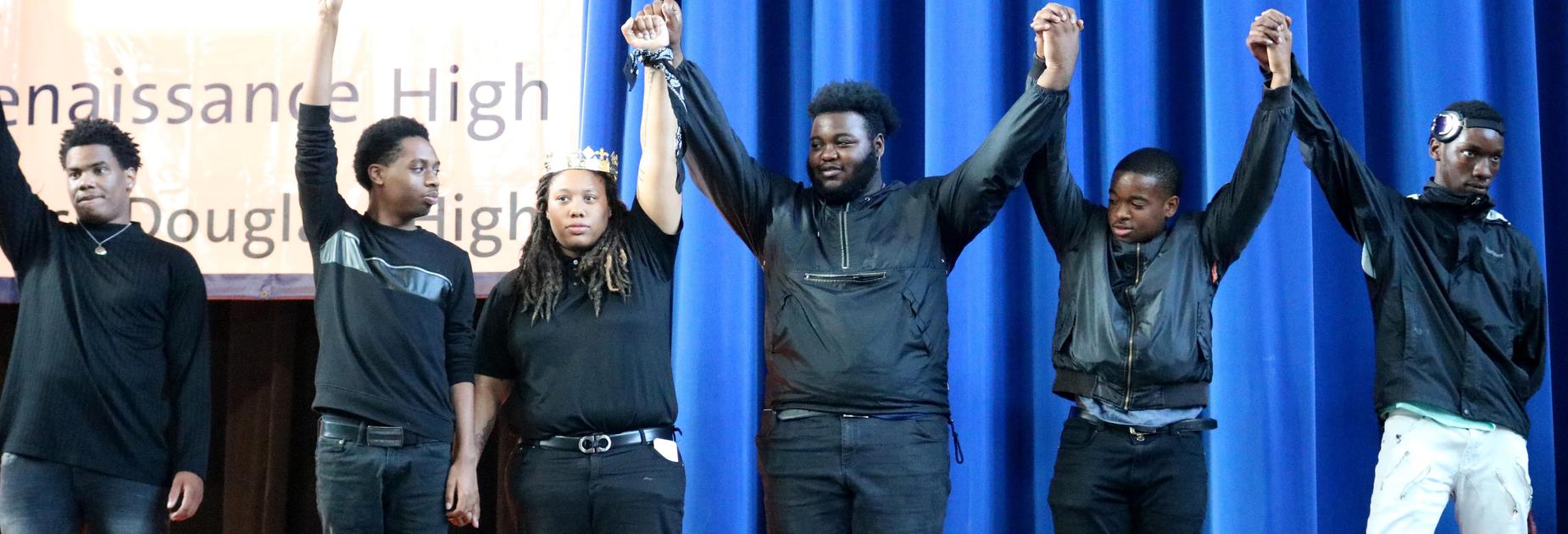 KRHS students holding hands above their heads at the talent show