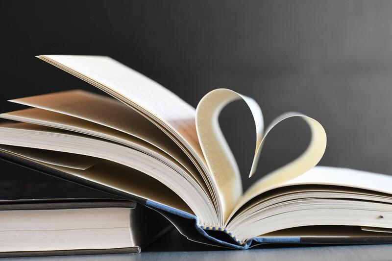 a book with pages folded into a heart symbol