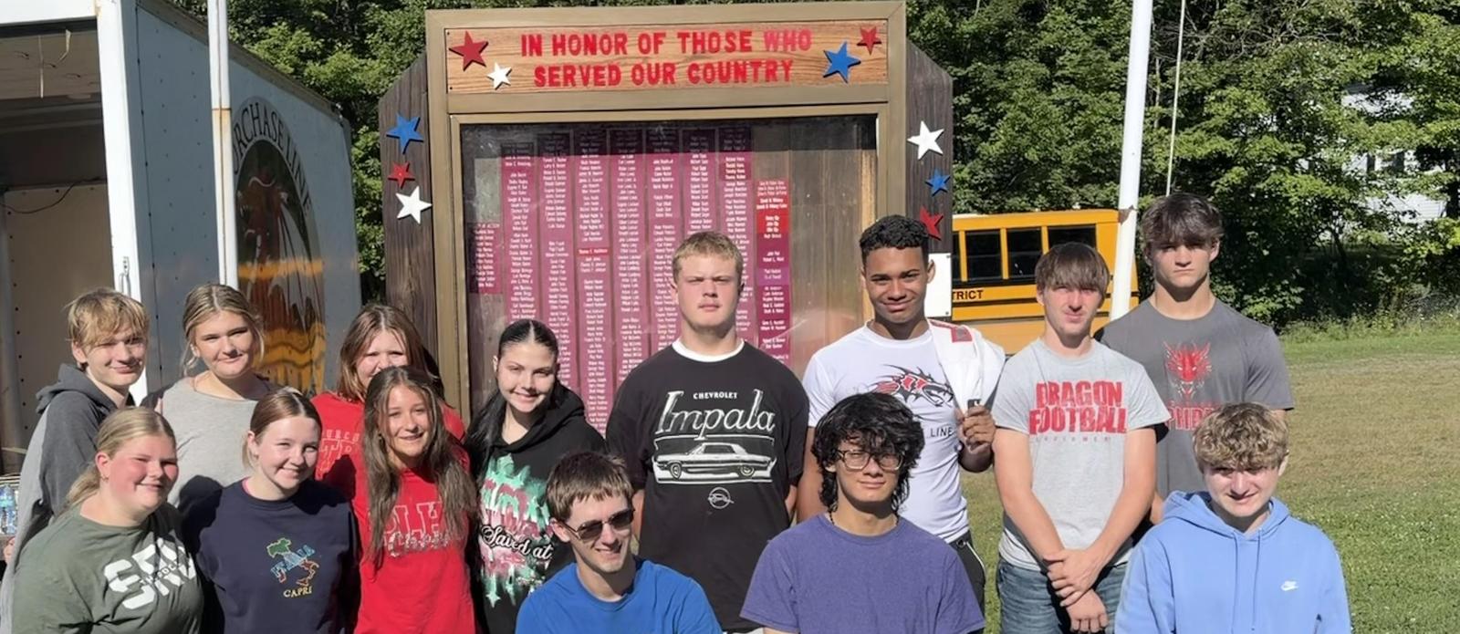 Students posed in front of the Commodore War Memorial that they refreshed on the Day of Caring