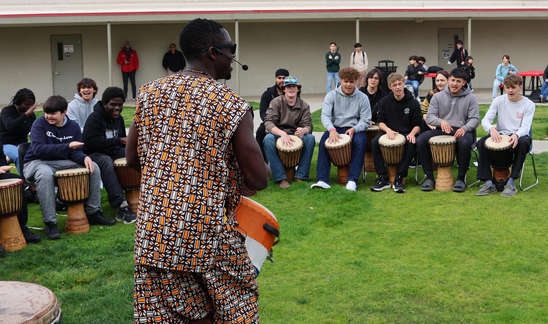 students and staff participating with the African Drum Interactive
