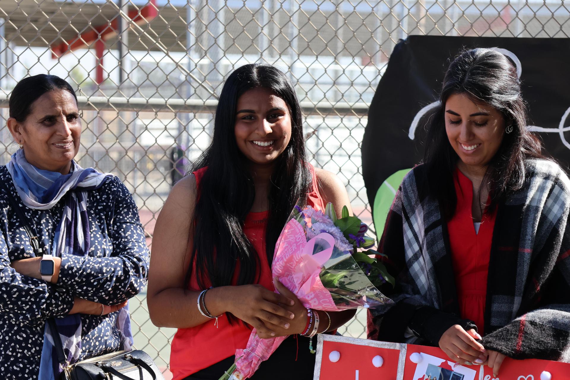 tennis players, family, and staff celebrating senior night