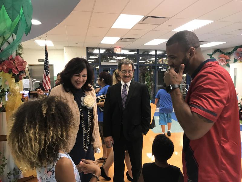 mrs diaz and mr perrigine laughing with a new student and her family on back to school night