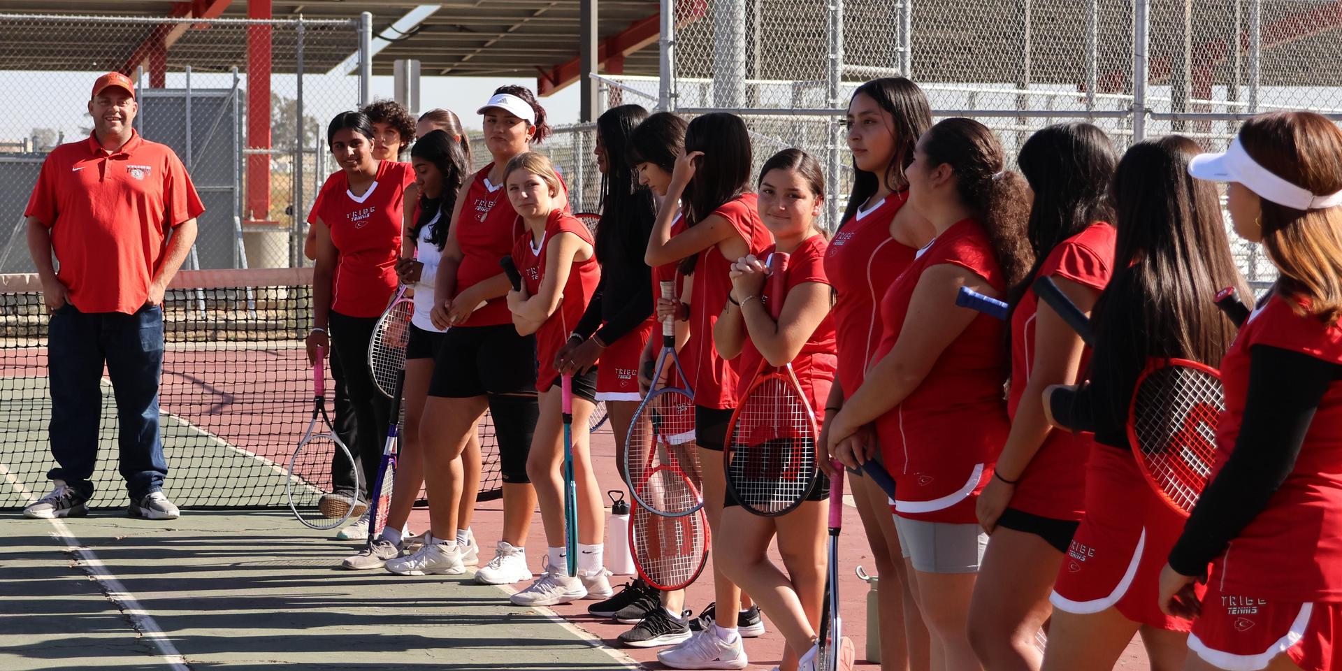 tennis players, family, and staff celebrating senior night