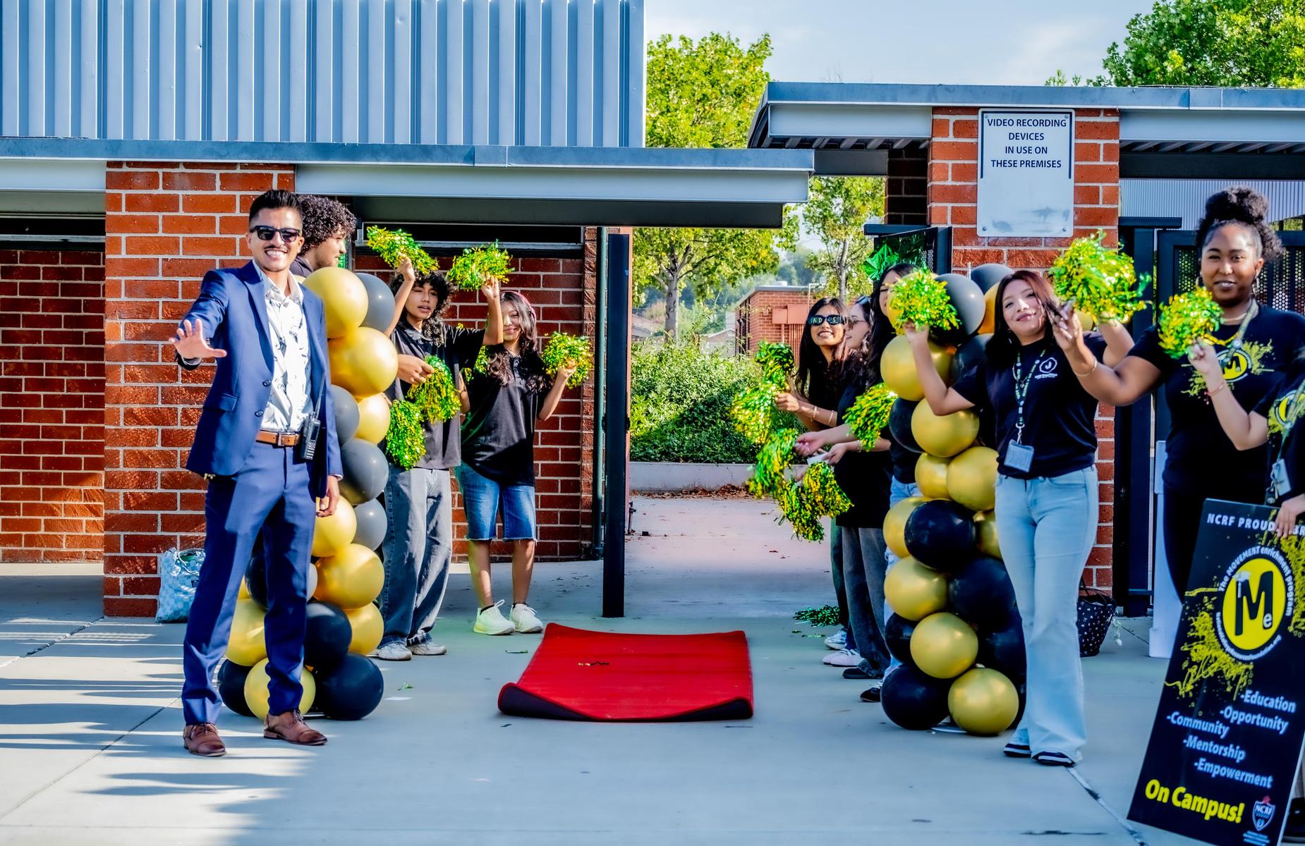 principal and students and red carpet at school