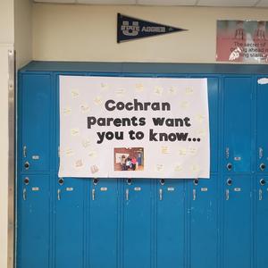 Hallway poster on blue lockers reading "Cochran parents want you to know..." surrounded by parents' handwritten sticky notes such as "You matter," "You are loved," and "You can do hard things."