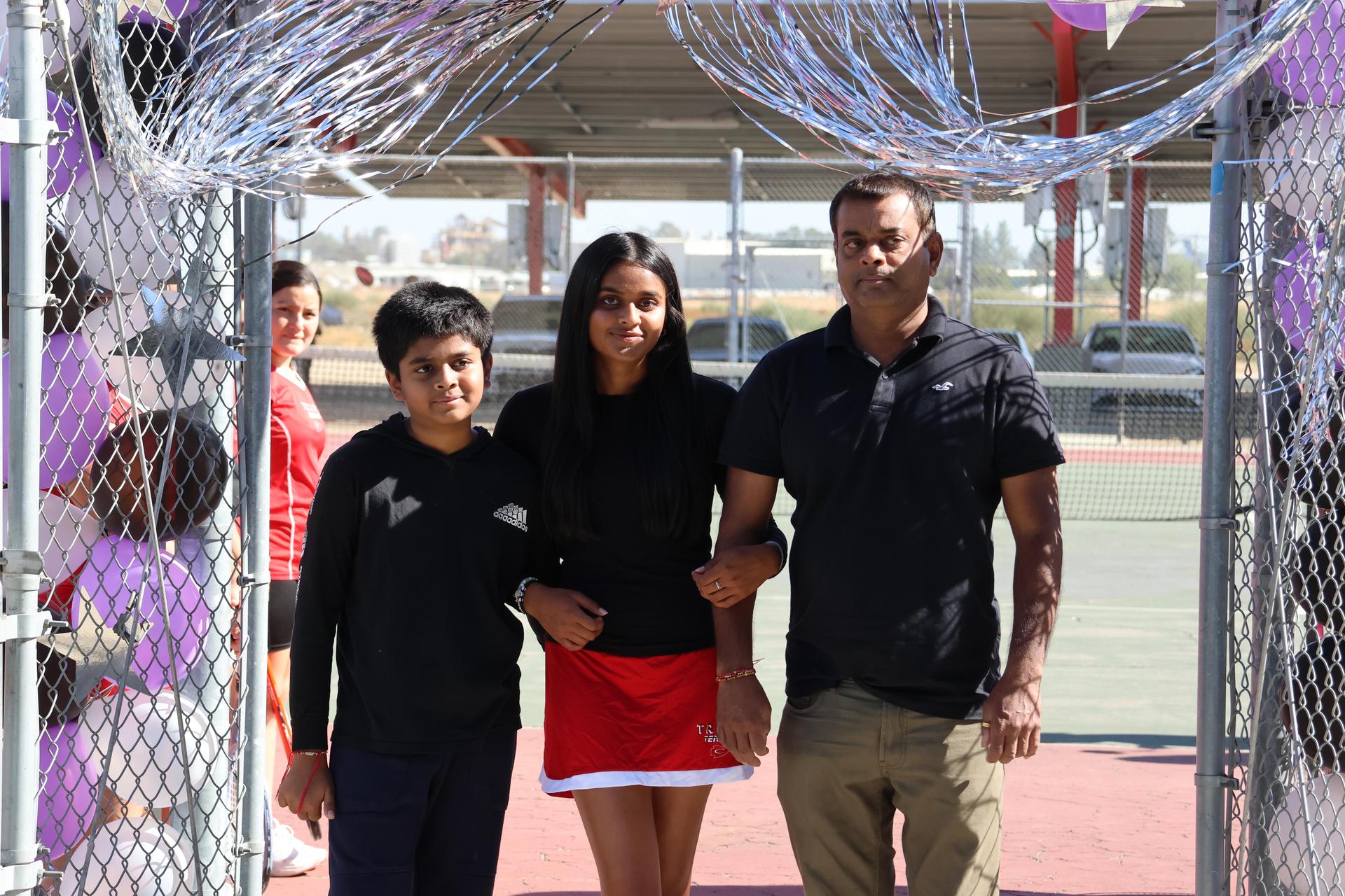 tennis players, family, and staff celebrating senior night