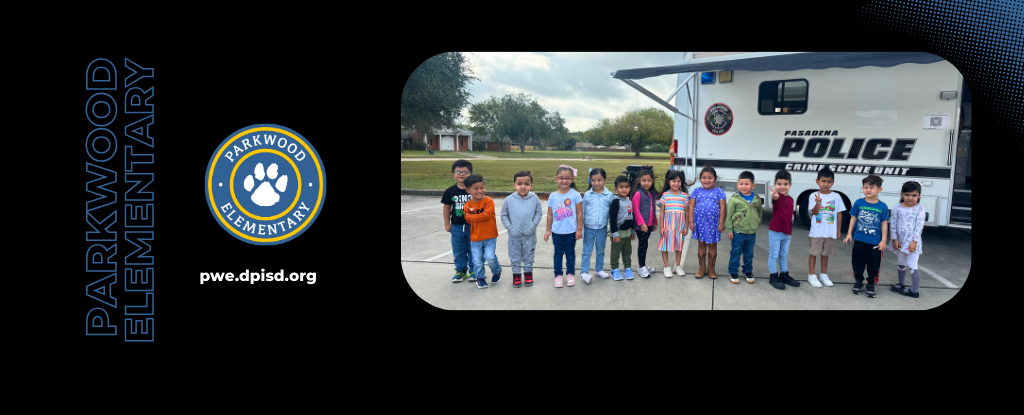 Students standing in front of a police vehicle at Parkwood Elementary.