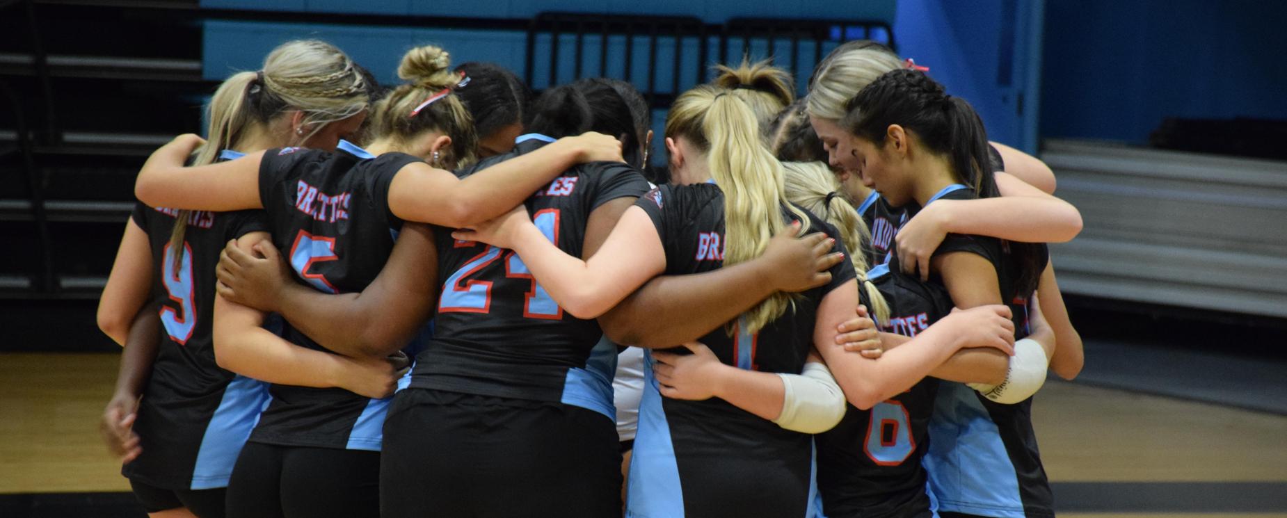 Volleyball team in huddle