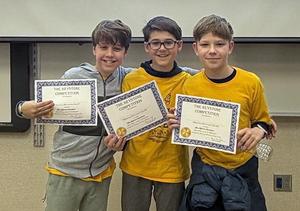 Three students hold certificates