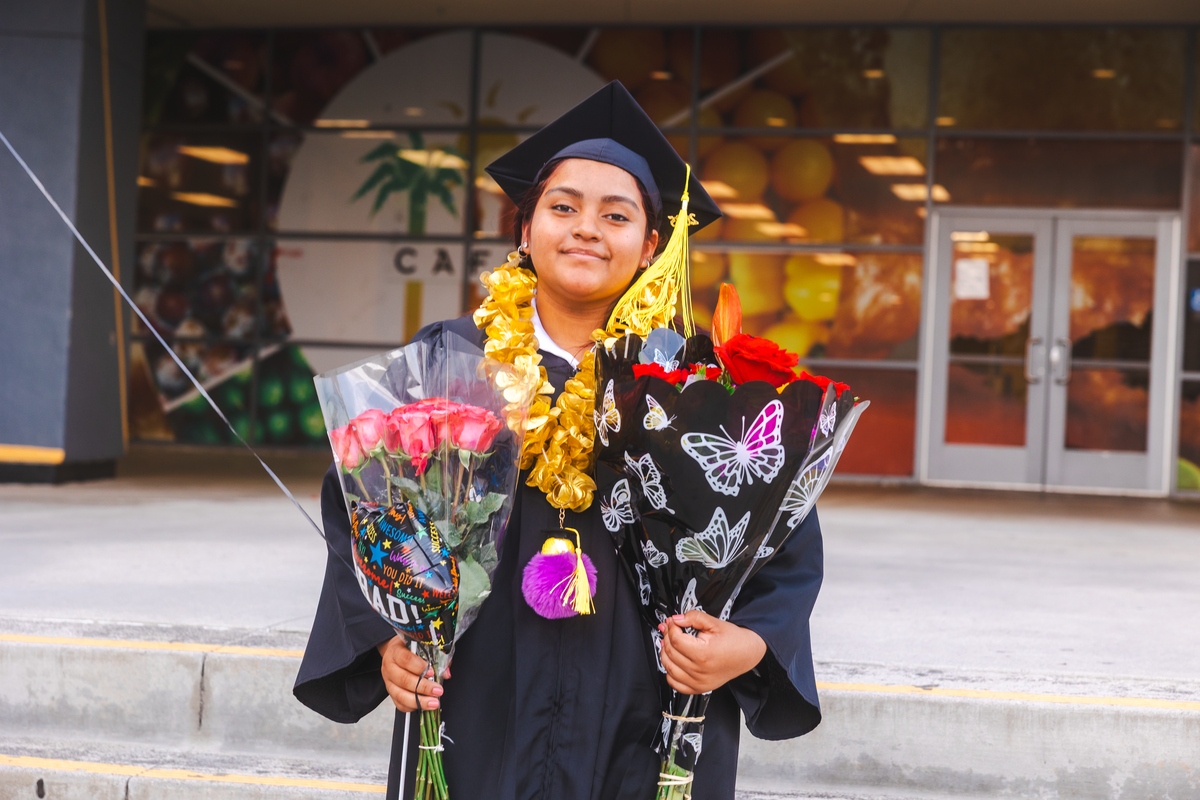 Graduate With Two Floral Bouquets