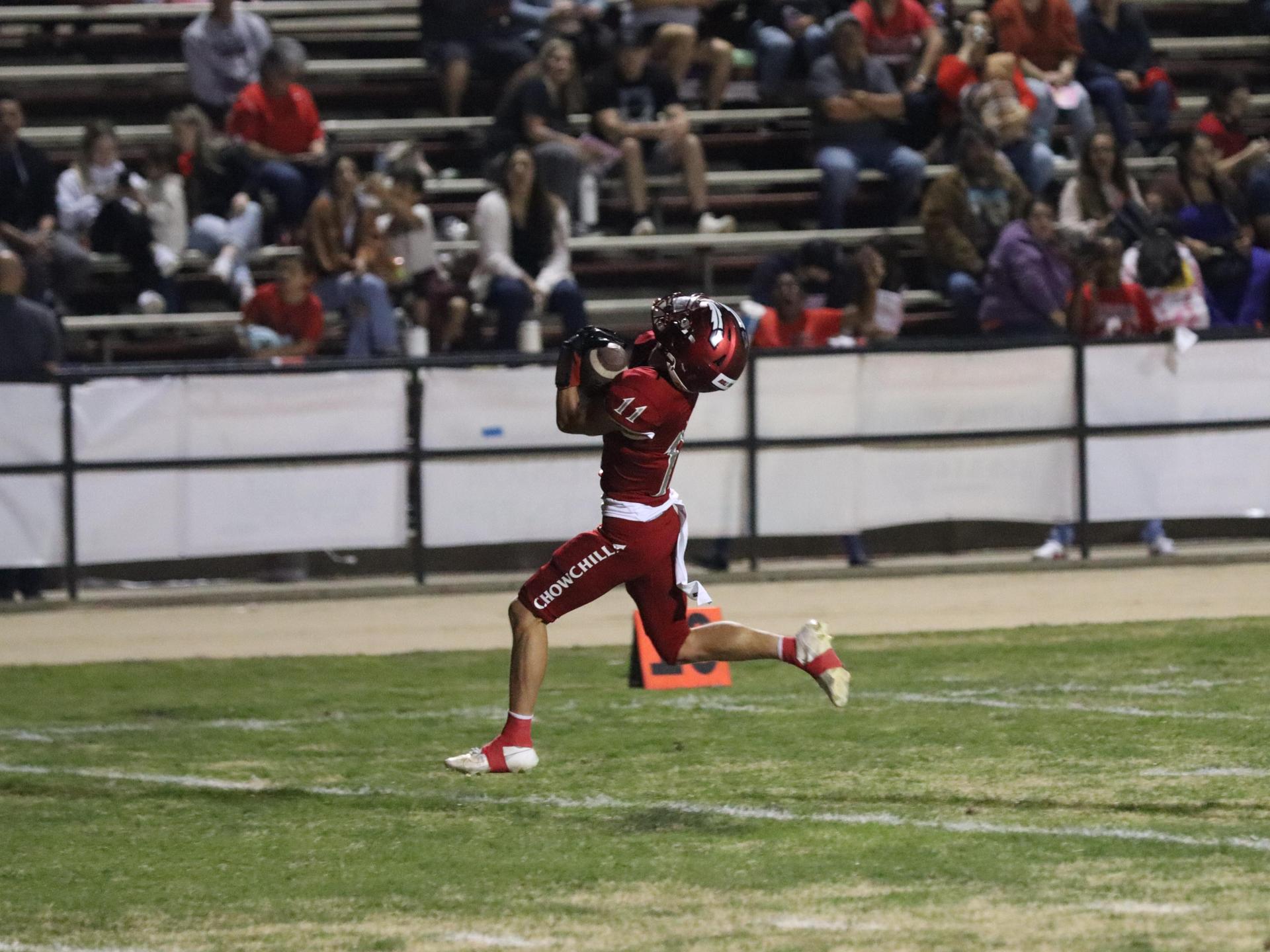 varsity football players in action against Riverdale