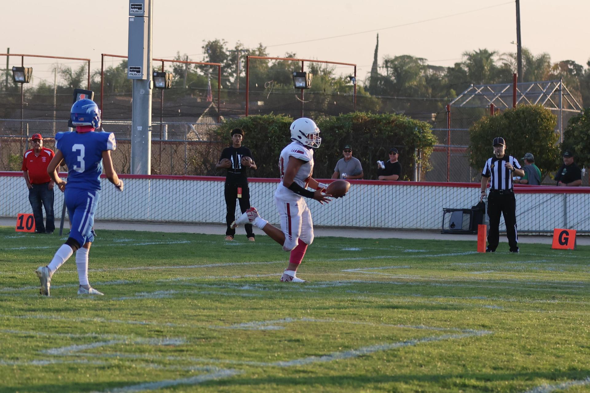 Junior Varsity football players in action against Caruthers
