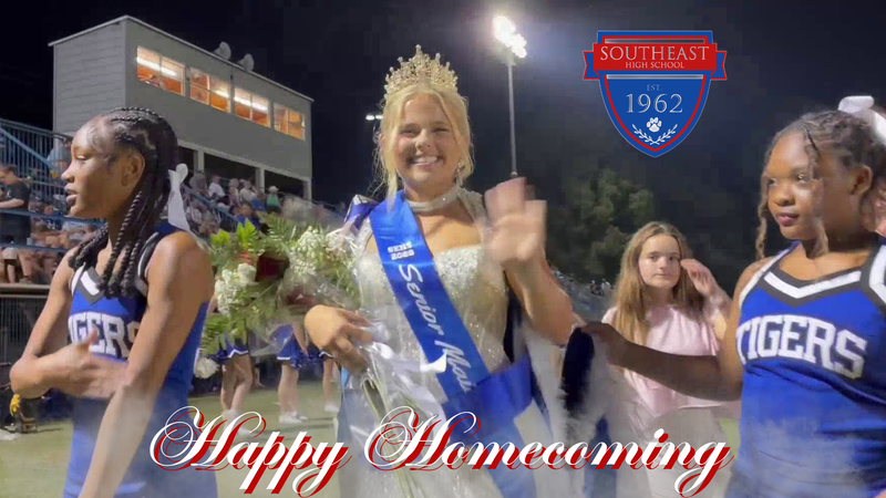 SEHS Homecoming Queen with Two Cheerleaders and Football Fans in the Bleachers/Stands