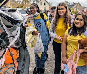 Students dressed like Minions enjoy trunk or treat