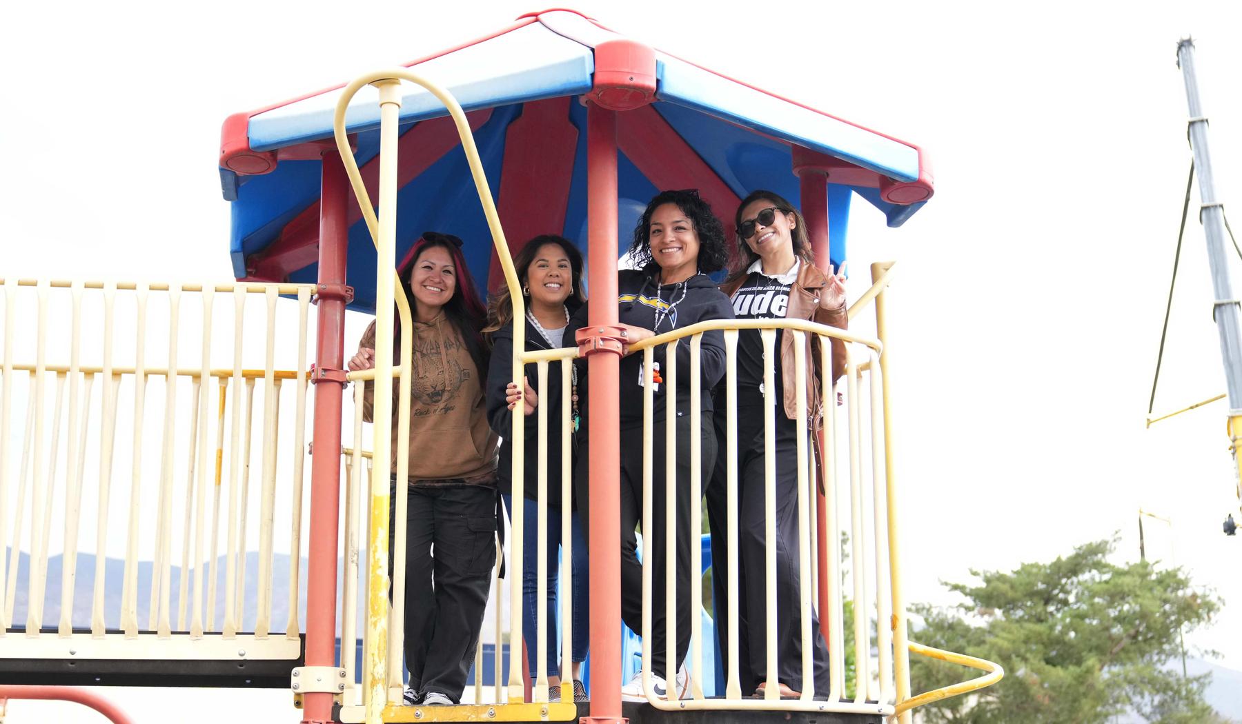 four staff members on the playground tower