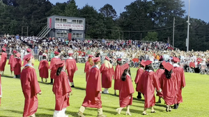Northeast High School graduation seniors marching onto the field