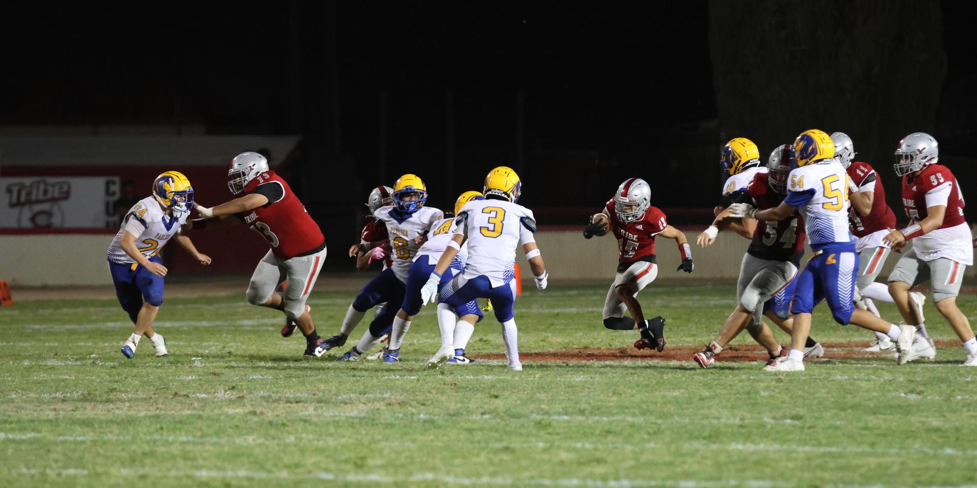 Varsity football players in action against Parlier 56