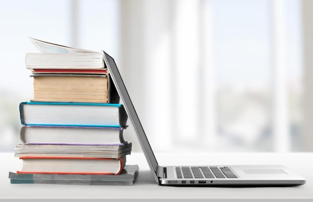 Picture shows textbooks and a chromebook.