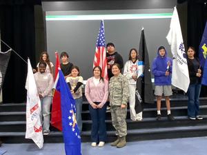 Harrison students honor veterans by holding flags and taking picture