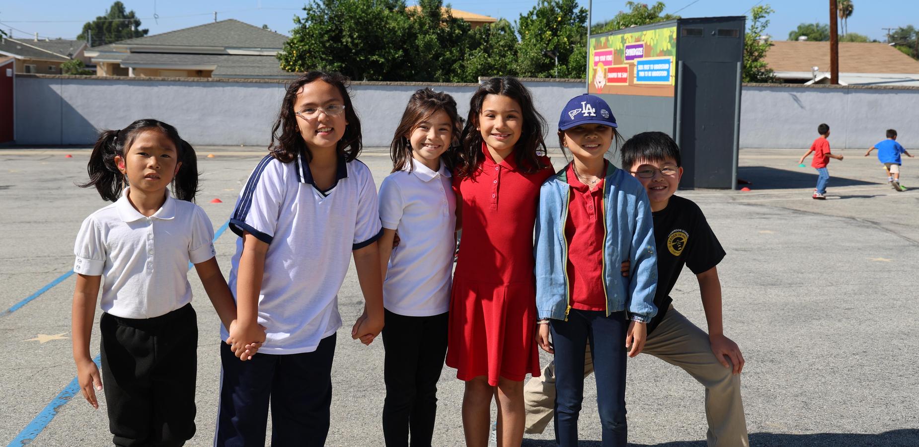 Students posing together on a school playground.