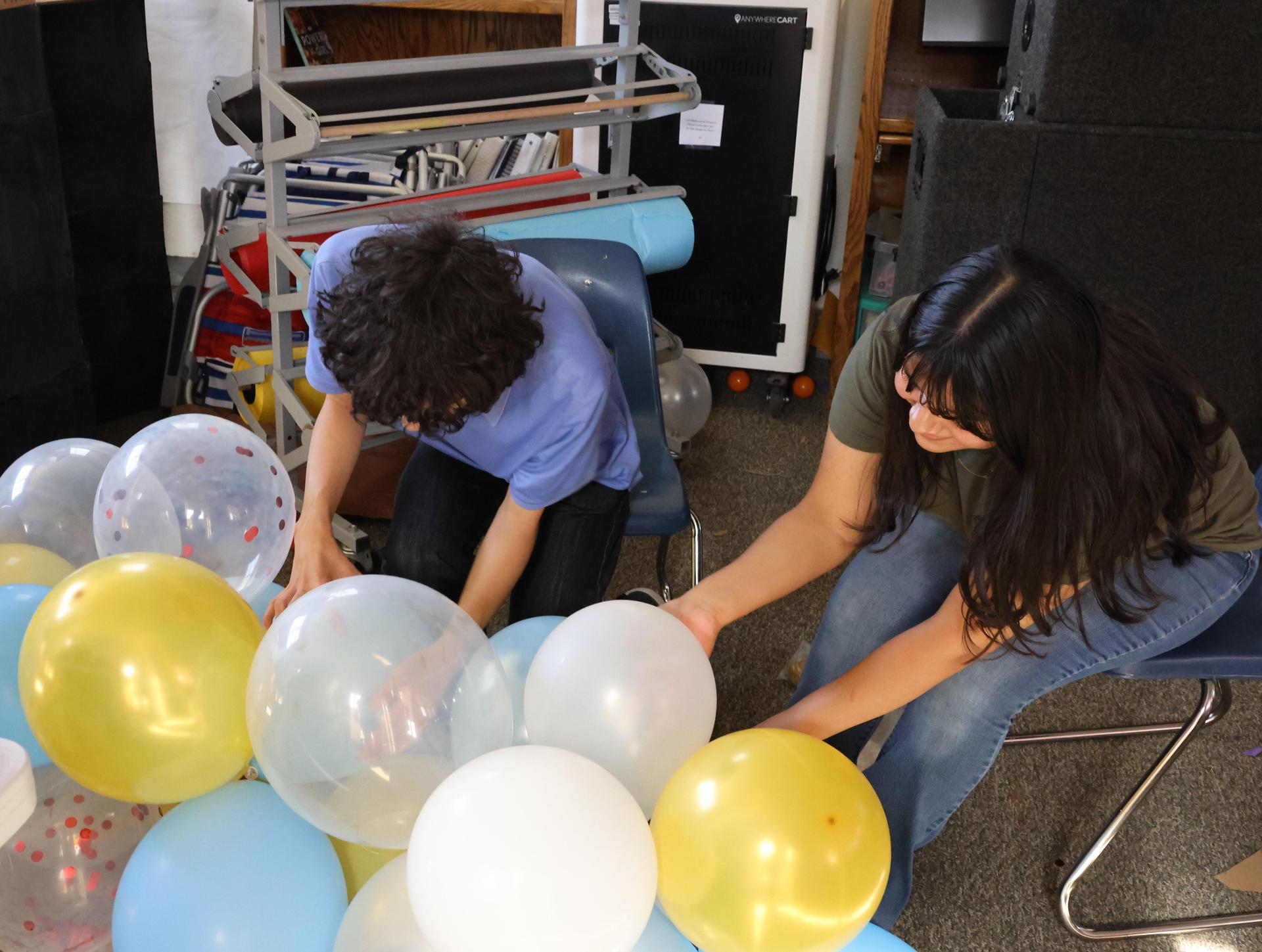 students, parents, and staff building floats for homecoming