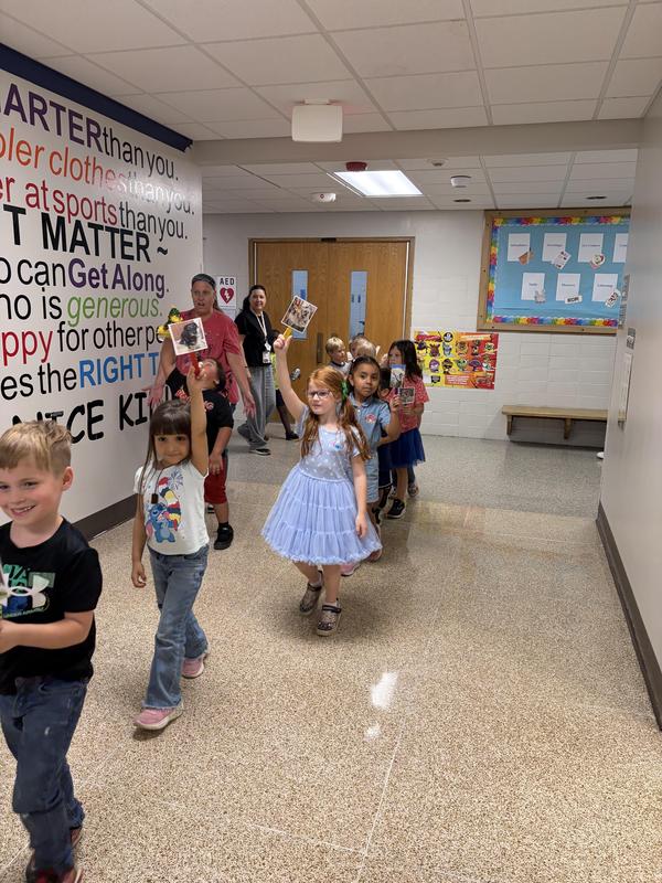Students holding pictures of their pets